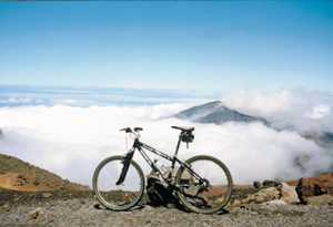 Photo of Ted’s rental bike further than previous photo down the mountian headed to the Pacifc Ocean in Maui, Hawaii.
