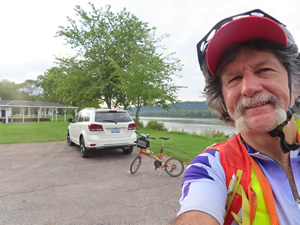 Ted, his rental car and his bike in park at West Point, Kentucky.