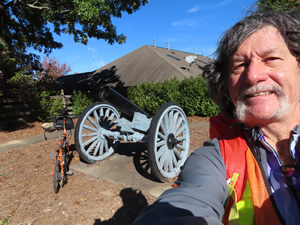 Ted’s bike on the Jane Addams trail near the WiscoTed in front of American revolutionary war cannon at Guilford Courthouse National Military Park.nsin boarder.
