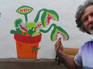 Ted next to mural on building in Miamisburg, Ohio.