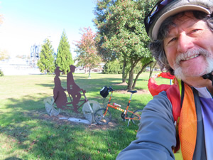 Ted and his bike with a trail side sculpture seen from the Chattanooga river trail.