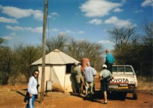 At the water pump on the Hlekweni training center.  Left to right - Becky, men we picked up, Ezra, truck guide, John and Karen.