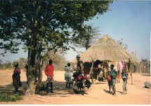 Ezra on his bike in front of the hut of the woman that I gave my sweat pants to.