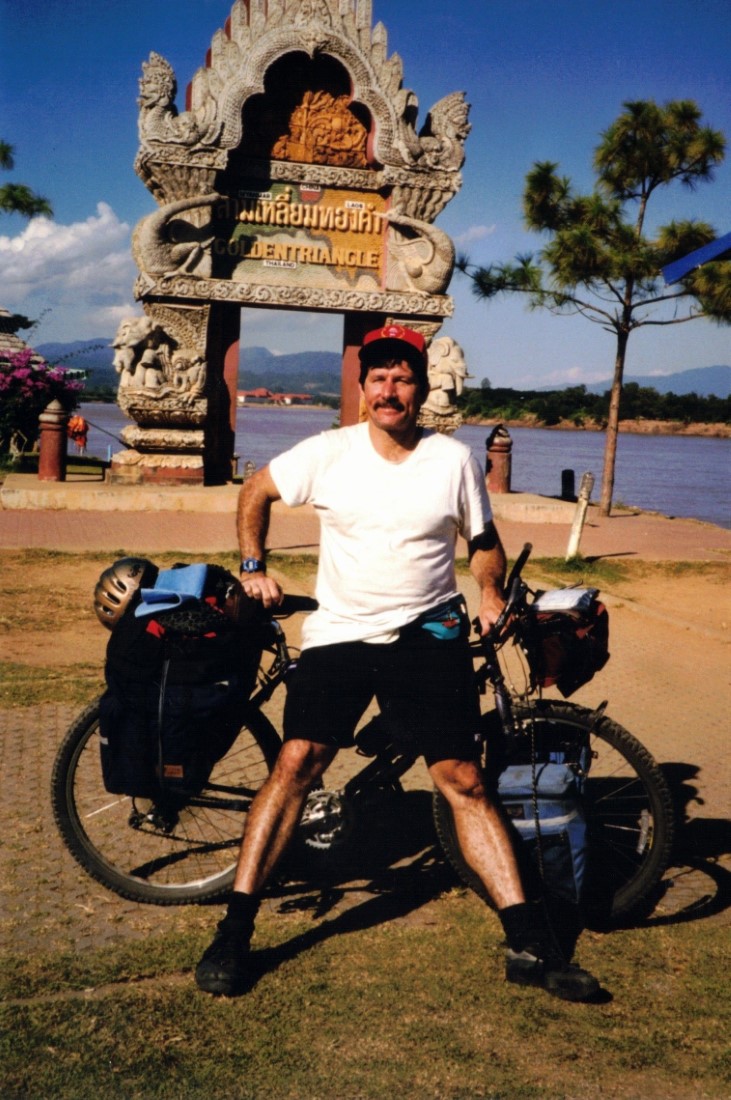 Me with my bike standing in front of the Golden Triangle monument in Sop Ruak, Thailand.