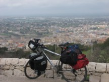 Ted's bike in front of typical Sicilian Town.