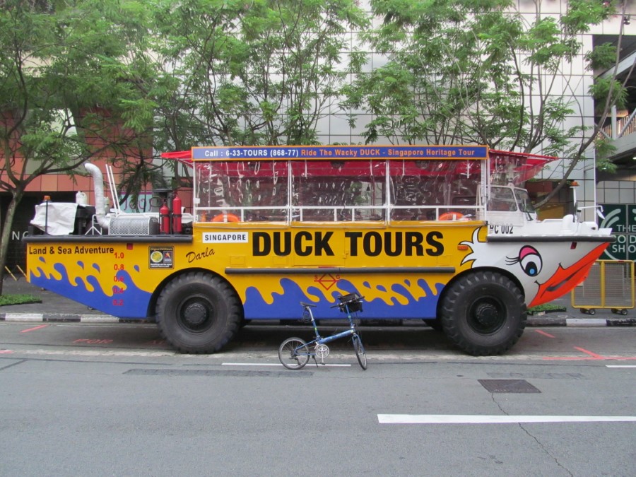 Ted&rsquo;s bike in front of one the Duck Tour vehicle in Singapore