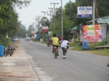 Guy pulling skate boarder in town south of Hua Hin, Thailand