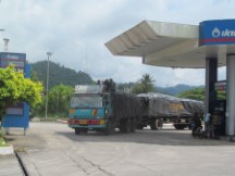 People riding the top of a truck in Thailand