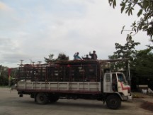 People riding on top of a truck in Thailand