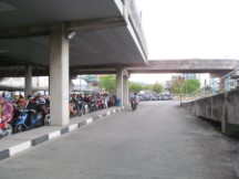 Motor scooter line to load ferry going from George town to Butterworth, Malaysia