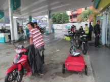 People waiting out Manson at gas station near Johor Bahru, Malaysia