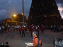 Female Santa dance group in front of Christmas tree in Guatemala City.