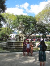 Ladies taking a photo in front of a fountain in Antigua, Guatemala