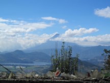 Photo of volcano looking over someone’s wall, note the glass is cemented into the wall so people will not enter the person’s yard.  This is a cheaper alternative to barbed wire fences.