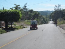 Typical highway view with 3 wheeled taxi. 