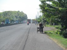 Typical highway view in El Salvador, here a man is taking a load of stuff somewhere on his bike, maybe the market. 