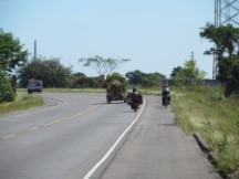 Typical highway view in El Salvador, here people are taking loads somewhere on his motorcycles and trucks, maybe the market.