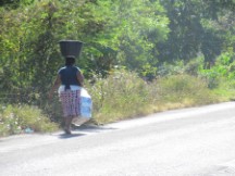 Lady carrying stuff on her head in Honduras