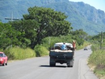 People riding in the back of a truck in Honduras