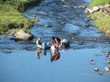 People cleaning their cloths in a river in Honduras