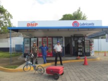 Ted’s bike with men that are running and guarding the lubricant store near gas station in Nicaragua.