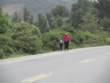 People walking along highway in Andes Mountains, Ecuador.