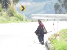 Man walking along highway in the Andes mountains of Ecuador.