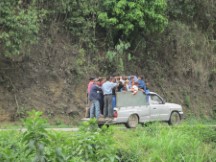 People being transported in the back of a truck at near 7,000 feet above sea level in Ecuador.