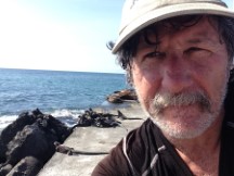 Ted with iguanas behind him on Isle Santa Maria, Ecuador.