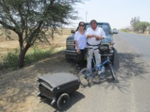 A man with his daughter next to highway between Chiclayo, Peru and Pacasmayo, Peru