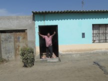 A friendly man at his front door between Chiclayo, Peru and Pacasmayo, Peru.