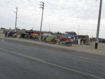 Three wheeled motorcycle taxis in a town between Pacasmayo, Peru and Trujillo, Peru.