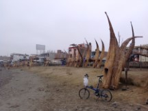 Ted’s bike with straw fishing boat on the beach of Huanchaco, Peru.