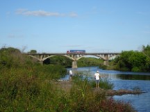 People fishing at the river near Dayman, Uruguay.
