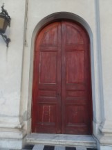 Small (this one is only about 10 feet tall, the middle one is about 15 feet tall) front door of the church in main square of Paysandu, Uruguay.