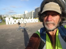 Ted and his bike in front of the Montevideo, Uruguay city entry sign.