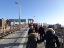 People crossing the Brooklyn Bridge in New York City.