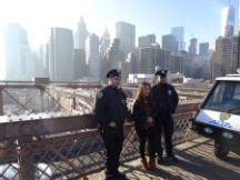 Police posing with a lady on Brooklyn Bridge in New York City.