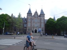Amsterdam – Cyclist on cell phone with child