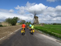 Netherlands – Nancy and Nancy in front of Ted about to pass another windmill.