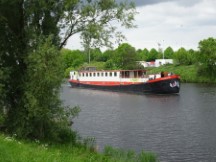 Netherlands – Our barge boat the Angelina floating to our next stop, we are cycling.
