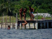 Kuna Indians throwing their friend in the ocean, San Blas islands, Panama.