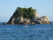 Paddle boarder at bay of Tangolunda, Mexico.
