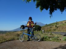 Ted with his bike and Volcanos in background near Antigua, Guatemala.