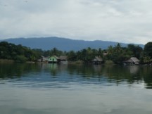 Homes on the shore of the Rio Dulce between the town of Rio Dulce and Livingston, Guatemala.