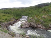 The river next to the road with the 8% grade hill south of Alta, Norway.