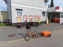 Ted’s bike and women from Finland on small bike tour.  They were bike camping in the backwoods and this photo was taken in front of the ICA grocery store in Korpilombolo, Sweden.