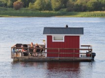 House boat in water near Grand Arctic Hotel in Överkalix, Sweden.