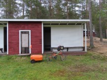 Ted’s bike in front of the lake changing room where he slept at Sanabadets campground in Sweden.