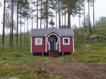 Small room at home near Sanabadets campground in Sweden. Typical Sweden country house, clean and often has several small red structures. Part of a Sweden home.  Most of the country places have a main home with several other smaller structures.  Most of them are painted in this shade of red with white trim.